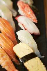 sushi on a black plate