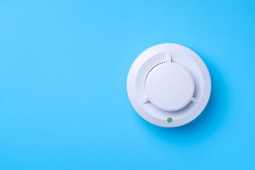 Fire detector on a blue background. Copy-space