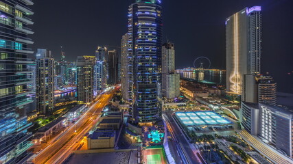 Fototapeta na wymiar Panoramic view of the Dubai Marina and JBR area and the famous Ferris Wheel aerial night timelapse