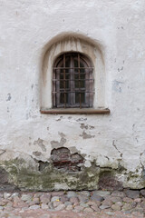 A small window with a lattice in the old tower