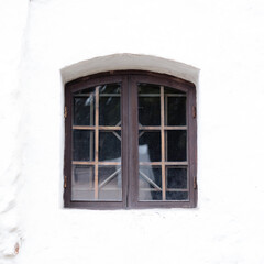 A small window with a lattice in the old tower
