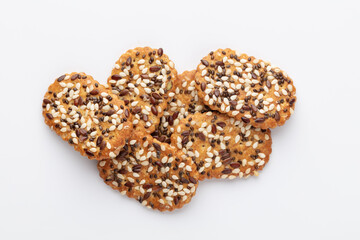 Tasty crackers with seeds on the white background.