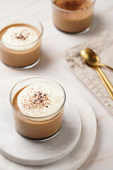 Italian chocolate and coffee mousse dessert semifreddo - half-frozen ice cream with whipped cream and cocoa powder in small glasses
