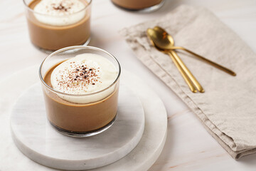 Italian chocolate and coffee mousse dessert semifreddo - half-frozen ice cream with whipped cream and cocoa powder in small glasses