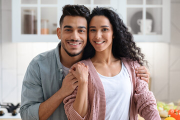 Portrait Of Happy Smiling Young Arab Couple Embracing And Smiling At Camera