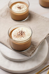 Italian chocolate and coffee mousse dessert semifreddo - half-frozen ice cream with whipped cream and cocoa powder in small glasses