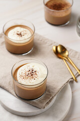 Italian chocolate and coffee mousse dessert semifreddo - half-frozen ice cream with whipped cream and cocoa powder in small glasses