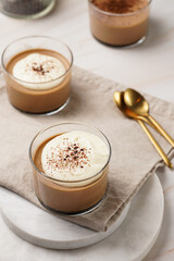 Italian chocolate and coffee mousse dessert semifreddo - half-frozen ice cream with whipped cream and cocoa powder in small glasses