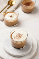 Italian chocolate and coffee mousse dessert semifreddo - half-frozen ice cream with whipped cream and cocoa powder in small glasses