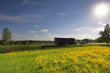 Landscape with a moving truck at sunset
