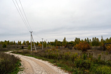 Fototapeta na wymiar a rural road of gravel on a cloudy day