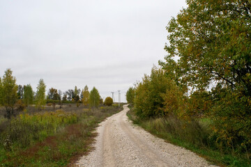 Fototapeta na wymiar a rural road of gravel on a cloudy day