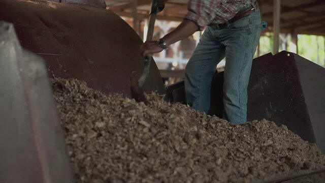 A farmer mixed food a wagyu cow in a cow stall at the Wagyu cow farm.