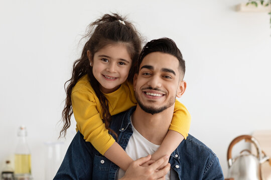 Father And Daughter Connection. Portrait Of Happy Little Arab Girl Embracing Dad