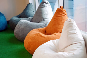 Bean Bags chairs standing in row, colorful beanbags. New soft and adjustable colorful beanbag...