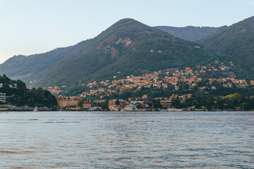 Fototapeta na wymiar Panoramic view of small charming towns by the lake shore in northern Italy 