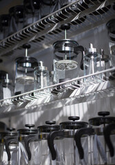 Glass transparent kitchen accessories for brewing coffee and tea on the shelf.