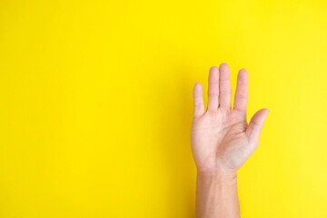 close up hand on yellow background