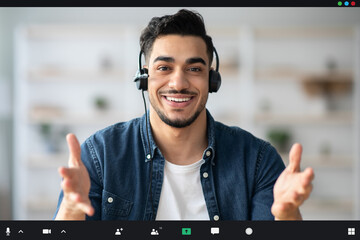 Positive middle-eastern guy with headset having conversation, pov screen