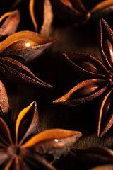macrophotography of star anise on a wooden background. brown spice star anise is close