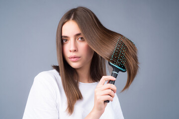 Woman brushing straight natural hair with comb. Girl combing hair with hairbrush. Hair care beauty concept. Brushing Hair.