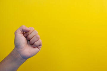 Naklejka premium close up hand on yellow background