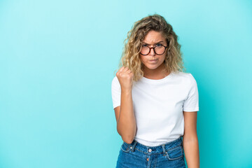 Obraz premium Girl with curly hair isolated on blue background with unhappy expression