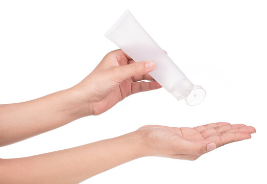 Hand holding blank squeeze bottle plastic tube isolated on white background.