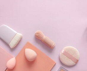 Makeup accessories, brushes and sponges,pink pastel background,flat layot