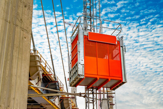 Construction elevator, lifts workers towards the new cable-stayed bridge under construction. Construction equipment.