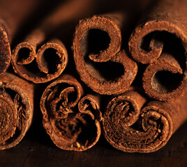 cinnamon and cassia sticks are close. brown condiment sticks on the side