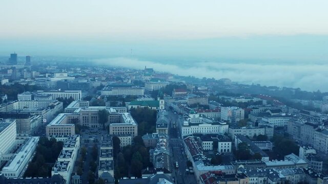 Aerial panoramic footage of buildings in central town district. Morning view with fog around river. Warsaw, Poland