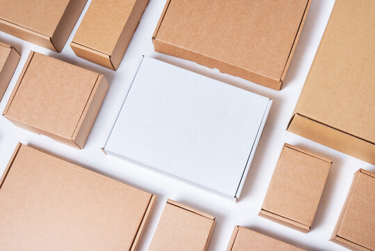 Brown cardboard box on white wooden background