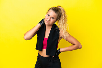 Sport woman with towel isolated on yellow background with neckache