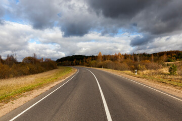 an asphalt road in the autumn season