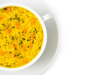 Chicken noodle soup in white bowl isolated on white background. Top view. Copy space