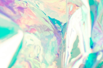 Blurred holographic background. Fluid multicolored abstract texture of wrinkled foil in turquoise colors.
