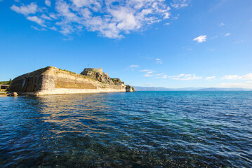Fototapeta na wymiar Corfu Castle old fort Greek island surrounded by blue sea sky and mountains a tourist attraction in Mediterranean Greece. 