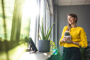 Active woman enjoying planting. Woman planting flowers. Woman plant care at home. Portrait Of Happy...