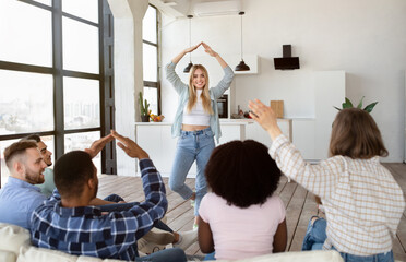 Group of cheerful diverse friends playing charades guessing game at home - obrazy, fototapety, plakaty