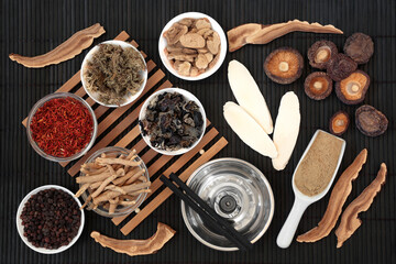 Chinese moxibustion treatment with moxa sticks, herbs and spice used in traditional herbal plant medicine. Natural health care concept. On bamboo background.  
