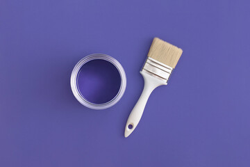 Paint brush with an open can of paint on trendy Very Peri background. Color of the year 2022. Top...