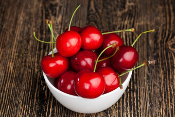 red ripe sweet cherries on a wooden table