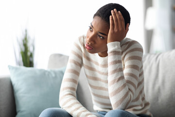 Depression Concept. Portrait Of Upset African American Woman Sitting On Couch