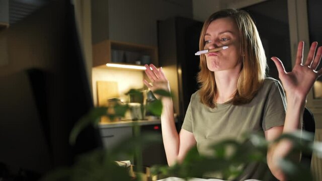 Freelancer woman sitting at workplace and procrastinating. Lazy and distracted employee at remote work