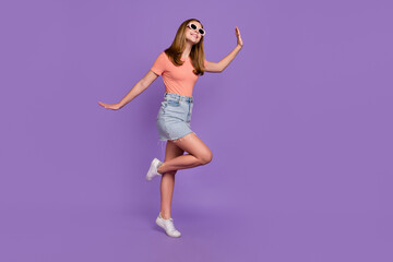 Full length body size view of attractive funky cheerful girl dancing having fun summertime isolated on shine violet purple color background