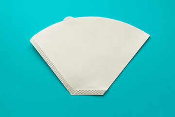 Bleached paper coffee filter for immersion brewing isolated on a colored pink background....