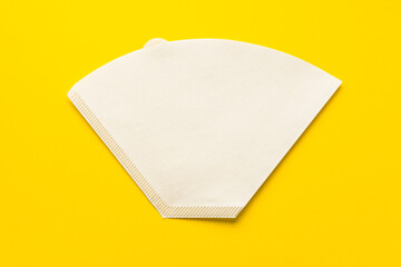 Bleached paper coffee filter for immersion brewing isolated on a colored pink background. Alternative brewing v60 pour over method. Minimalistic abstract yellow background