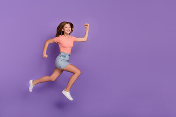 Fototapeta na wymiar Full length body size view of attractive cheerful funky girl jumping running copy space isolated on bright violet purple color background
