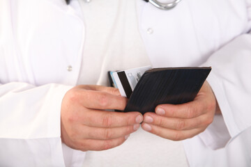 man holding credit card and tablet